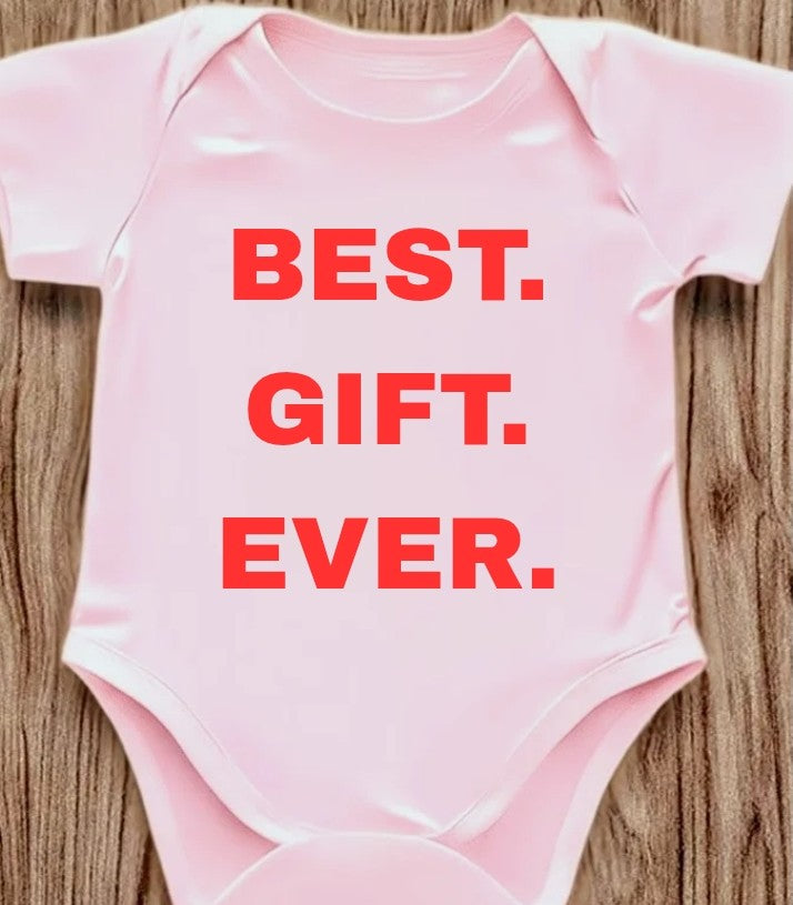 Funny baby onesie with the text 'Best.Gift.Ever.' on a wooden background