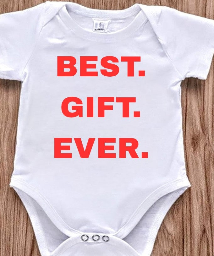 Funny baby onesie with the text 'Best.Gift.Ever.' on a wooden background